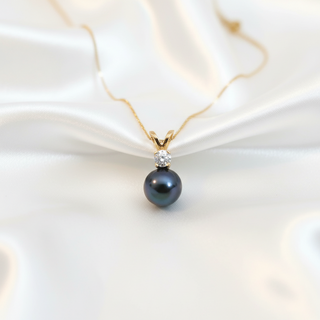 Pearl necklace with a gold chain on a white background