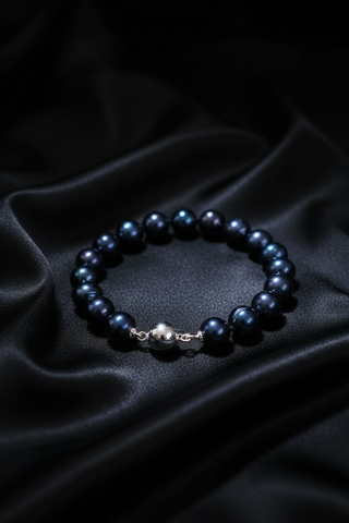Midnight blue freshwater pearls  bracelet on a dark fabric background