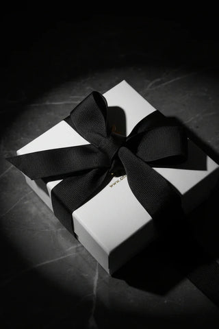 Elegant white gift box with black ribbon, perfect for luxury pearl jewelry presents