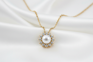 A halo diamond necklace featuring a pearl at its center.