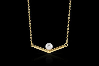 Gold necklace with a pearl pendant on a black background