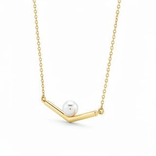Elegant gold necklace with a single pearl on a minimalist bar pendant