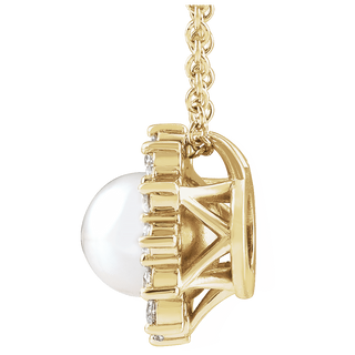 A close-up side view of a yellow gold pendant necklace featuring a large white pearl and small clear accent stones, shown on a plain white background.