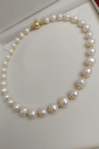 Handcrafted white pearl necklace with gold spacers in a white jewelry box