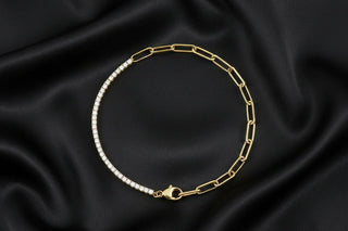 Gold chain bracelet with diamond accents on black silk fabric