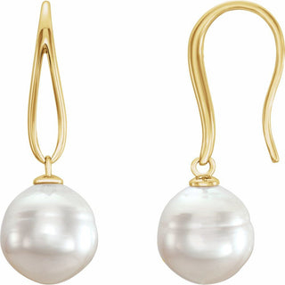 Gold earrings with large white pearls on a white background