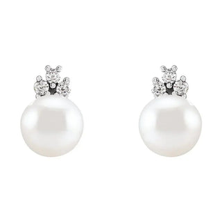 Pearl earrings with small diamonds on a white background