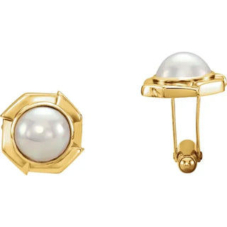 Gold cufflinks with pearls on a white background