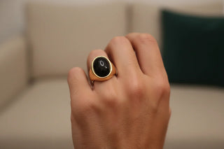 Male finger wearing black onyx ring