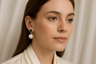 a model wearing onyx and pearl earrings 