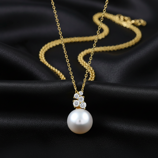 Gold necklace with Akoya pearl and diamond accents on black satin background