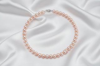 Pearl necklace on a white satin background