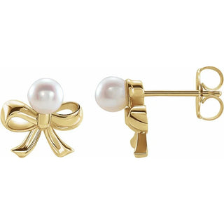 Gold bow stud earrings with round white pearl accents