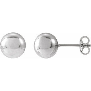Pair of white gold ball earrings on a white background