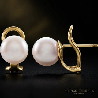 14K gold cultured pearl omega earrings by Whitestone Jewellery on a dark background